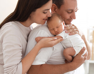 Mother and father with their newborn baby at home