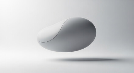 A smooth, gray object floats in a minimalist white space. It appears abstract, with an organic form and subtle gradient, possibly a design element.

