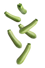 Fresh ripe zucchinis falling on white background