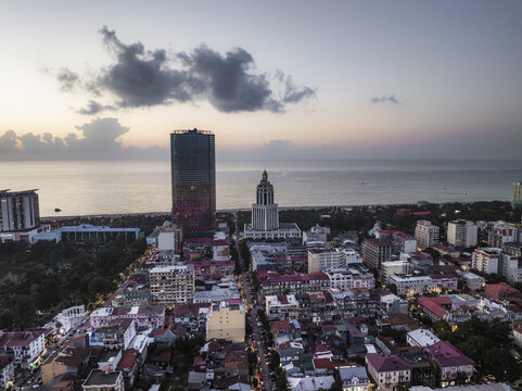 Aerial view of the cityscape where the Radisson Blu Hotel Batumi and the Alphabet Tower stand tall against the serene Black Sea horizon, Batumi, Adjara, Georgia.