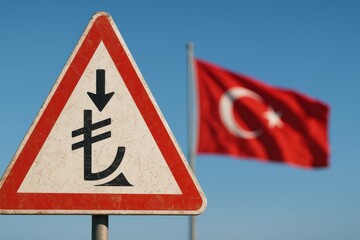 Falling Turkish lira currency concept with warning sign and national flag economic crisis