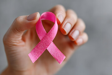 Breast Cancer pink ribbon awareness on woman hand, bw color concept raising awreness campaign on female atient with breast tumor ilness (bow isolated with cipping path)