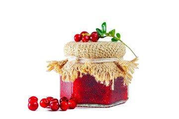 Jar of lingonberry jam with berries and lingonberry leaves isolated on white background. © lizavetta