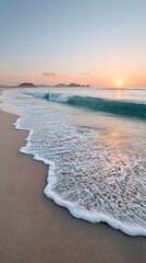 Tranquil waves gently wash onto a sandy beach at sunrise, creating a serene and peaceful coastal scene.