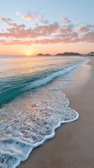 Serene sunrise over a sandy beach with gentle waves and distant mountains under a colorful sky.