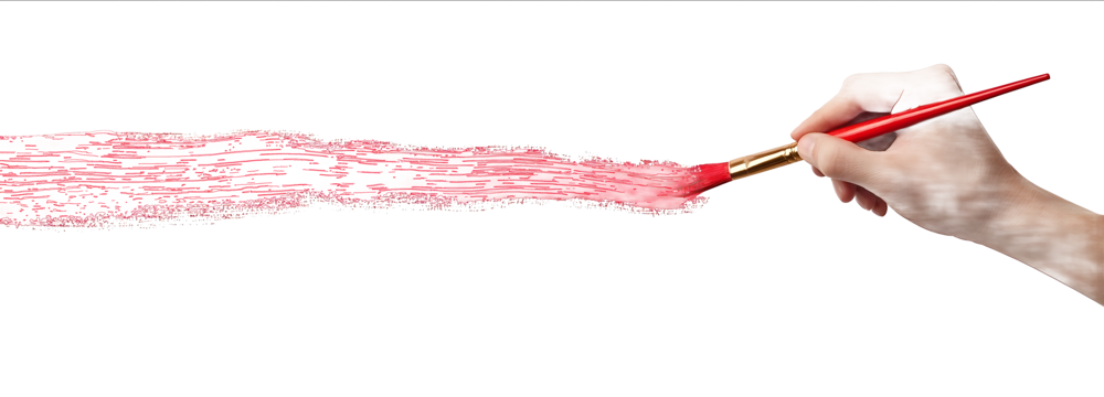 A hand holding a paintbrush is drawing a long red line on a white background isolated on a white background with a clipping path
