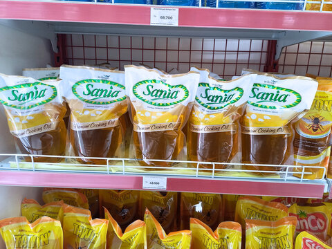 Denpasar, Indonesia - August 20, 2025: Sania cooking oil packages arranged on supermarket shelf, popular vegetable oil brand widely used in Indonesian kitchens.