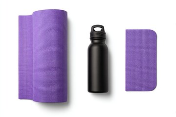 Purple yoga mat, black water bottle, and cloth; studio shot