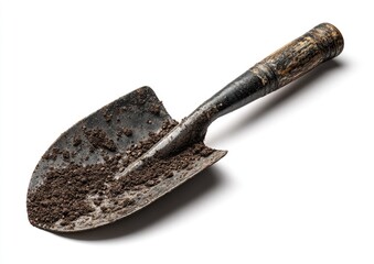 Close-up of a used trowel, covered in dark soil