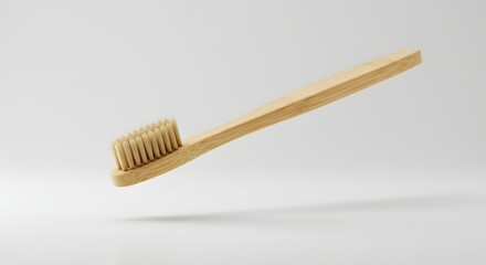 Eco-friendly bamboo toothbrush with natural bristles on a white background.