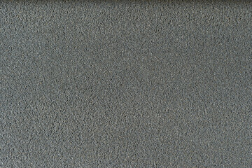 細かい小石の壁面のクローズアップ。背景・テクスチャ素材