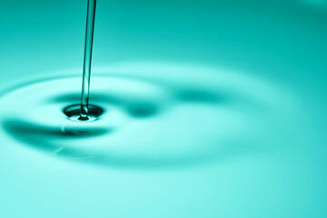 The oil flows and collects into a drop. The texture of the cosmetic product.