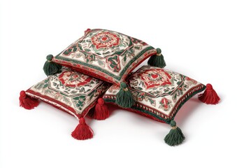 Three decorative pillows, stacked, displaying intricate floral embroidery in shades of red, green, and beige.  Red tassels accent each pillow