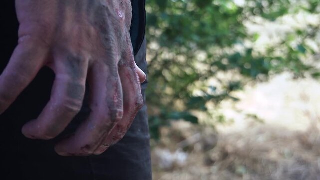  The killer waits for his victim with a knife in his bloody hand. 