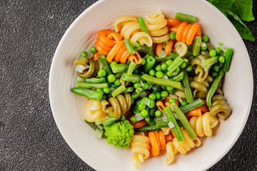 Trottole pasta vegetables green peas, green beans, kohlrabi cabbage, broccoli second course tasty snack fresh delicious gourmet food background on the table rustic food top view copy space