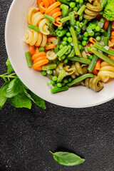 Trottole pasta vegetables green peas, green beans, kohlrabi cabbage, broccoli second course tasty snack fresh delicious gourmet food background on the table rustic food top view copy space