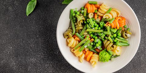 Trottole pasta vegetables green peas, green beans, kohlrabi cabbage, broccoli second course tasty snack fresh delicious gourmet food background on the table rustic food top view copy space