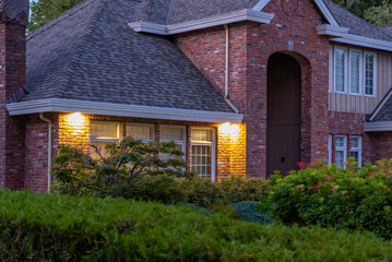 Two story stucco luxury house with big tree and nice landscape at night at Summer in Vancouver, Canada, North America. July 2025.