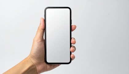 Close up of a person's hand holding a modern black smartphone with a blank white screen for mockup purposes, isolated on a neutral background