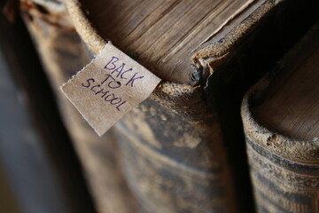 Back to School tag and Book on old wooden table.