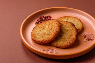 Hash browns, fried potato and onion pancakes with spices for breakfast. Fried hash browns