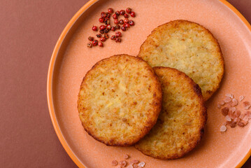 Hash browns, fried potato and onion pancakes with spices for breakfast. Fried hash browns