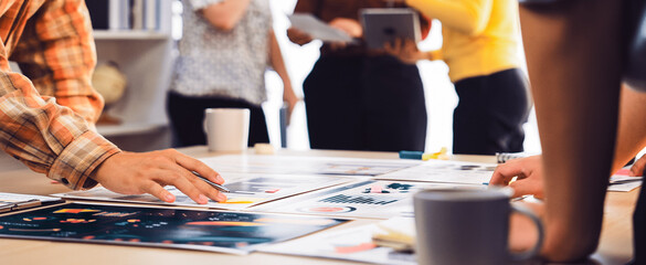 A dynamic workspace showcases a diverse team collaborating on creative projects, discussing...