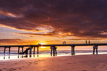 Fototapeta premium Butwani bridge and Malindi Pier area is a popular waterfront location known for stunning sunrises over the Indian Ocean. The pier is a concrete jetty that stretches about 400 meters into the ocean and