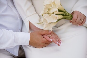 Wedding Rings and Calla Lilies: A Loving Ceremony Displaying Gold Bands, White Flowers, and Hands Representing Commitment and Vows.