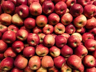 Fresh red apples stacked together, symbolizing healthy food, nutrition, agriculture, and organic produce in market display, perfect for promoting fruit, diet, and natural lifestyle