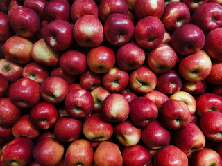 Fresh red apples stacked together, showcasing natural freshness, sweet flavor, and healthy nutrition. Perfect for diet, vegan meals, and organic lifestyle