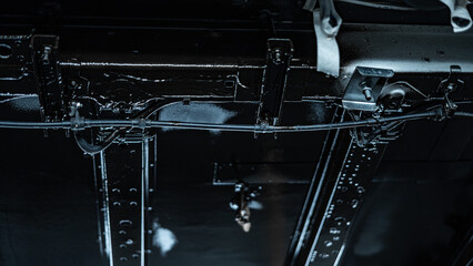 Automotive technician applying rustproof protective coating under a vehicle. Process helps prevent corrosion and extend vehicle lifespan. Ideal for illustrating car maintenance, vehicle care.