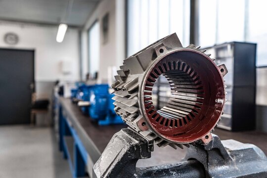 This collection of high-resolution images captures the intricate process of repairing and assembling electric motors inside a professional industrial workshop.