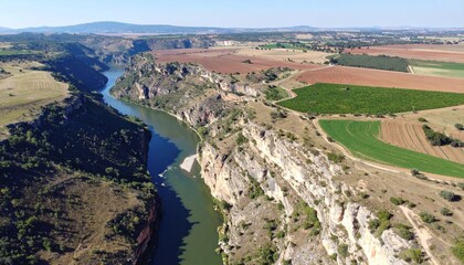 Aerial View of River Cutting Through Dramatic Cliff Landscape