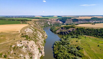 Fototapeta premium Scenic Aerial View of Serene River Winding Through Green Hills