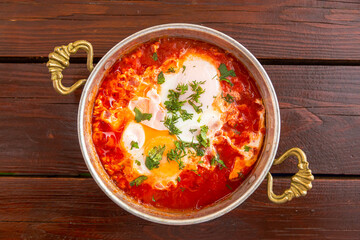 shakshuka with garlic and herbs in a small frying pan