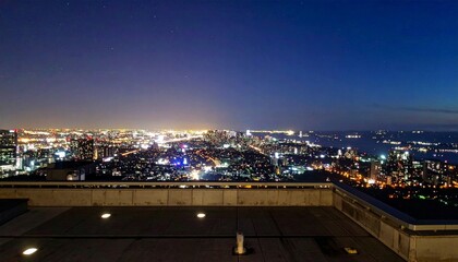 Fototapeta premium Night Skyline View of City with Illuminated Buildings and Streets