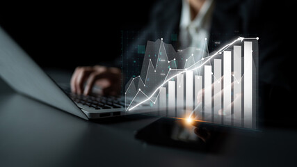 A professional engaged in analyzing financial data with a laptop, presenting growth trends through charts and graphs in a modern business environment for strategic insights. Impute