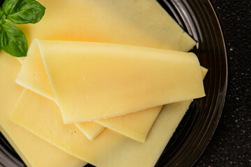 Gouda cheese slices hard cheese variety natural product tasty snack fresh delicious gourmet food background on the table rustic top view copy space