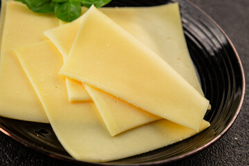 Gouda cheese slices hard cheese variety natural product tasty snack fresh delicious gourmet food background on the table rustic top view copy space