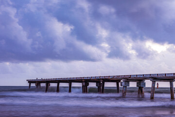 Obraz premium Butwani bridge and Malindi Pier area is a popular waterfront location known for stunning sunrises over the Indian Ocean. The pier is a concrete jetty that stretches about 400 meters into the ocean and