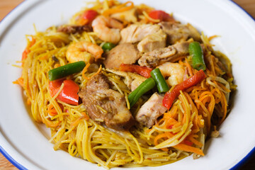 Plate of Tasty Spicy Singapore Noodles With Meat and Vegetables