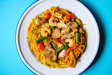 Plate of Tasty Spicy Singapore Noodles With Meat and Vegetables