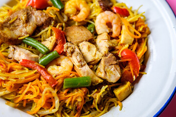 Plate of Tasty Spicy Singapore Noodles With Meat and Vegetables