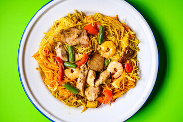 Plate of Tasty Spicy Singapore Noodles With Meat and Vegetables