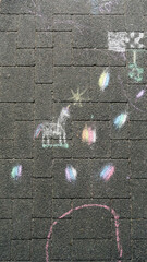 Colorful chalk drawings on a paved surface, including a unicorn and scattered, vibrant shapes and doodles.