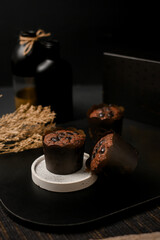 Assorted mini muffins—chocolate chip and cheese—on a small pedestal with dark background and copy space. Ideal for bakery ads, menus, packaging, and social media.