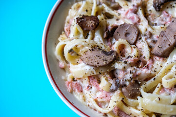 London UK, August 30 2025,  Bowl of Classic Ham and Mushroom Tagliatelle Pasta Meal With No People