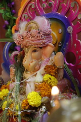 Ganapati festival celebration at home with a beautifully decorated Ganesh idol, flowers, lights, and traditional offerings, symbolizing devotion, prosperity, and cultural heritage in a festive atmosph