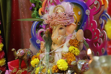 Ganapati festival celebration at home with a beautifully decorated Ganesh idol, flowers, lights, and traditional offerings, symbolizing devotion, prosperity, and cultural heritage in a festive atmosph